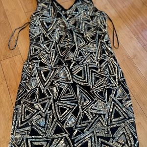 This night dress in gold and black is in very good condtion never wore it. New!
